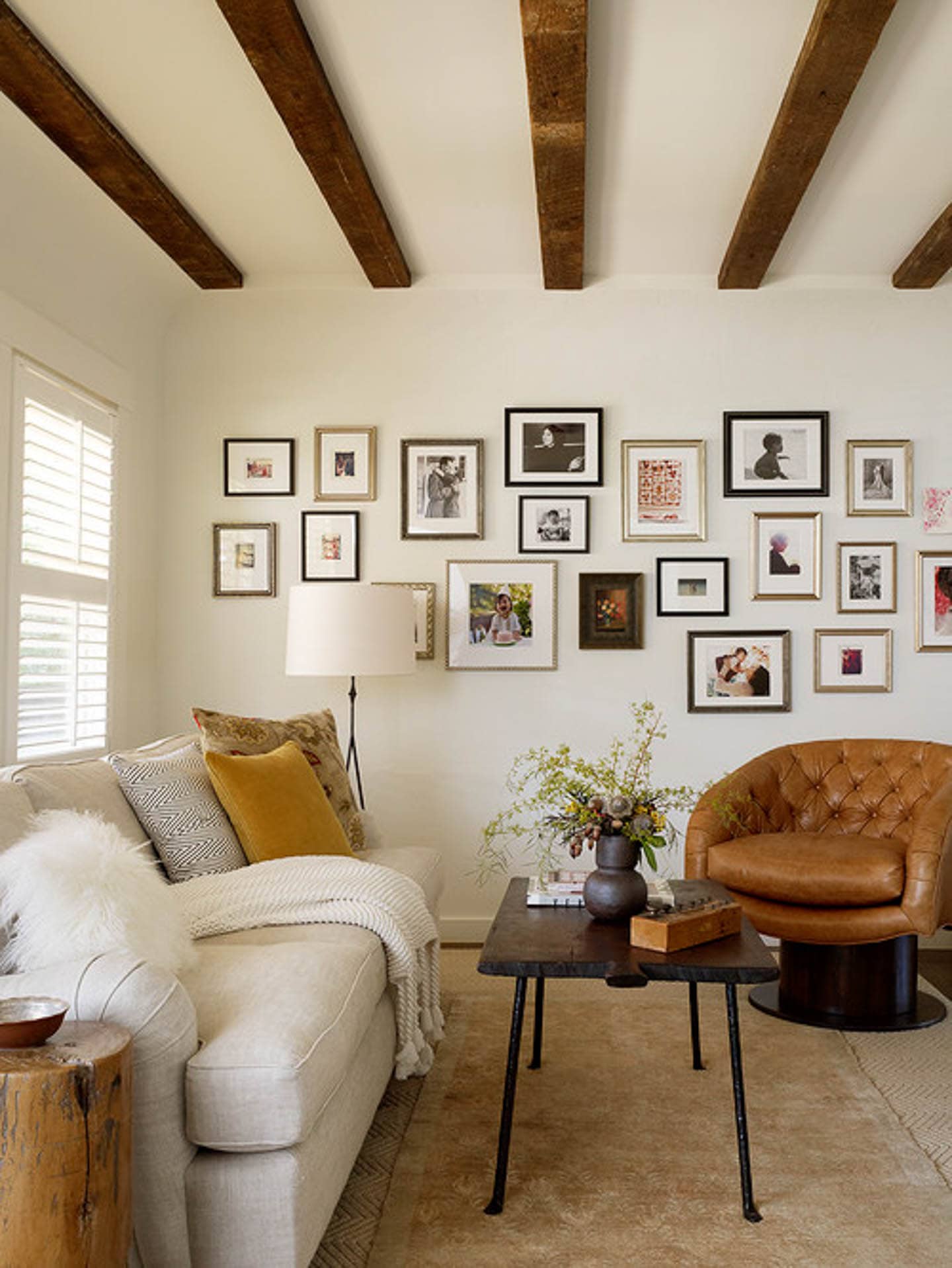 A cream living room with wood ceiling beams