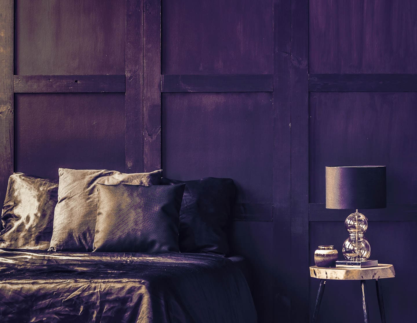 bedroom with dark purple walls, pillow and bedding