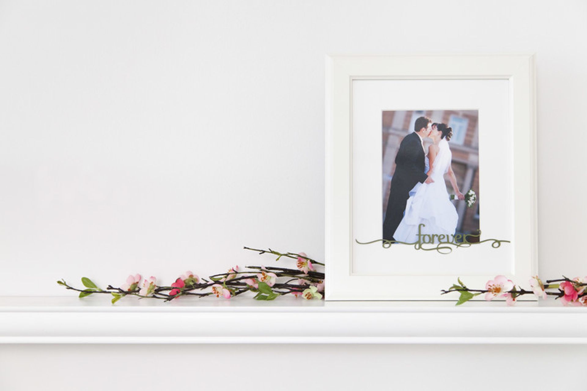 Framed picture of a bride and groom with the word Forever on the front of the frame
