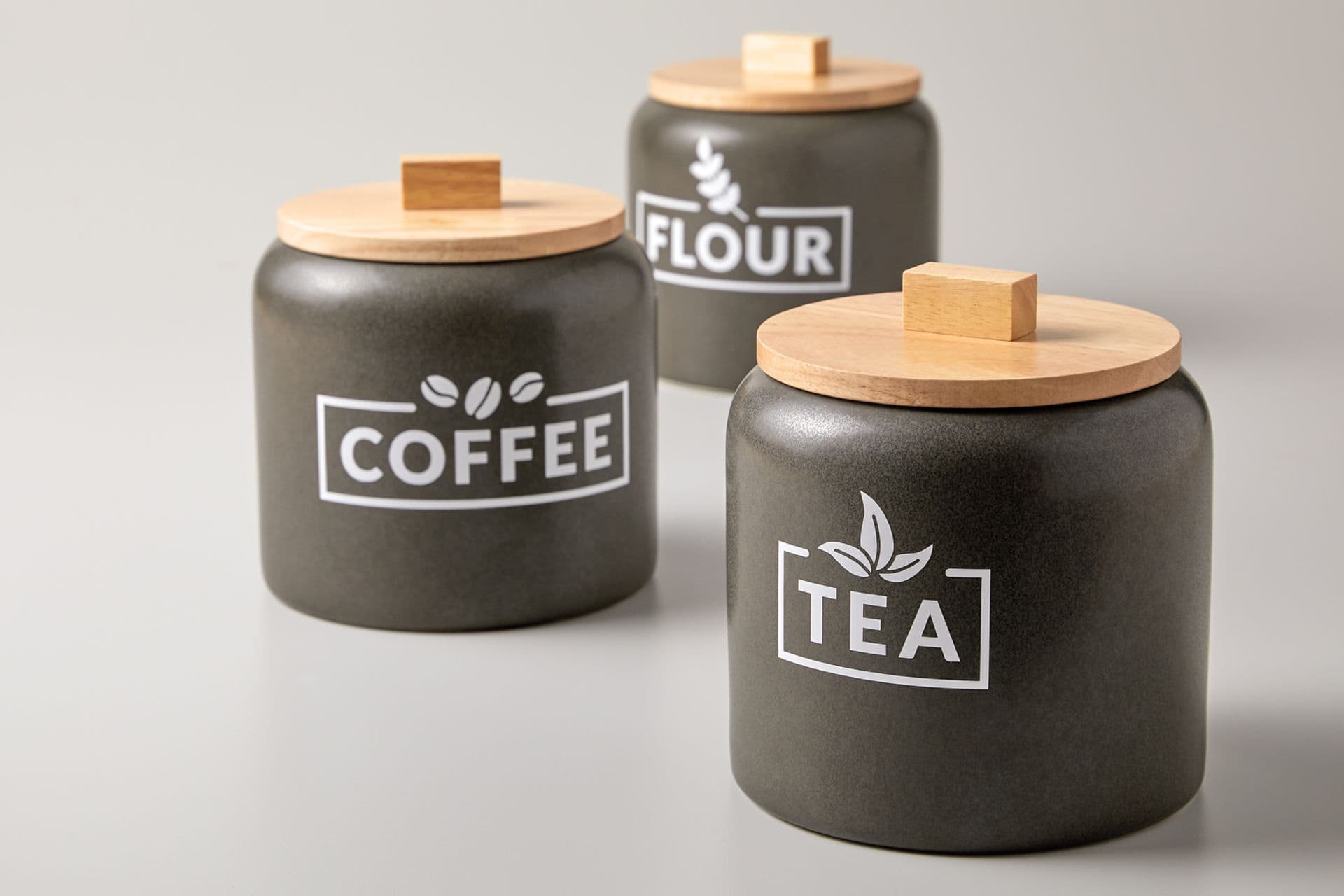 3 kitchen cannisters with Tea, Coffee and Flour labels made with a Cricut