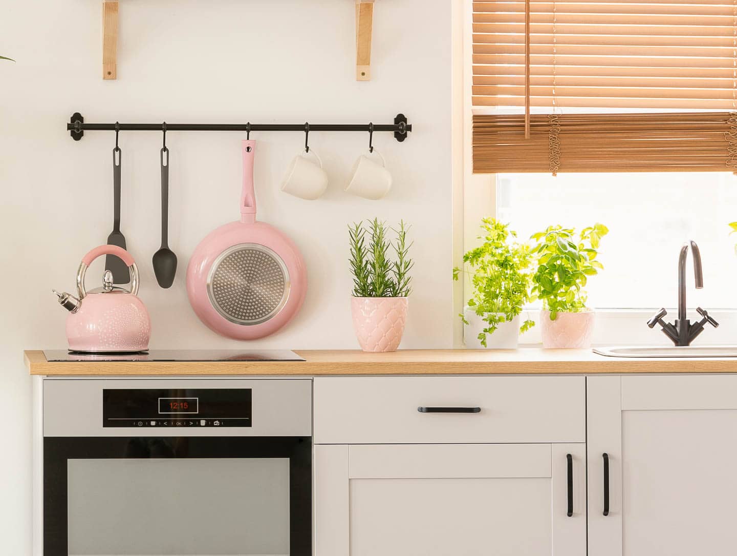 ivory kitchen with pink accessories - kettle, frying pan and planter