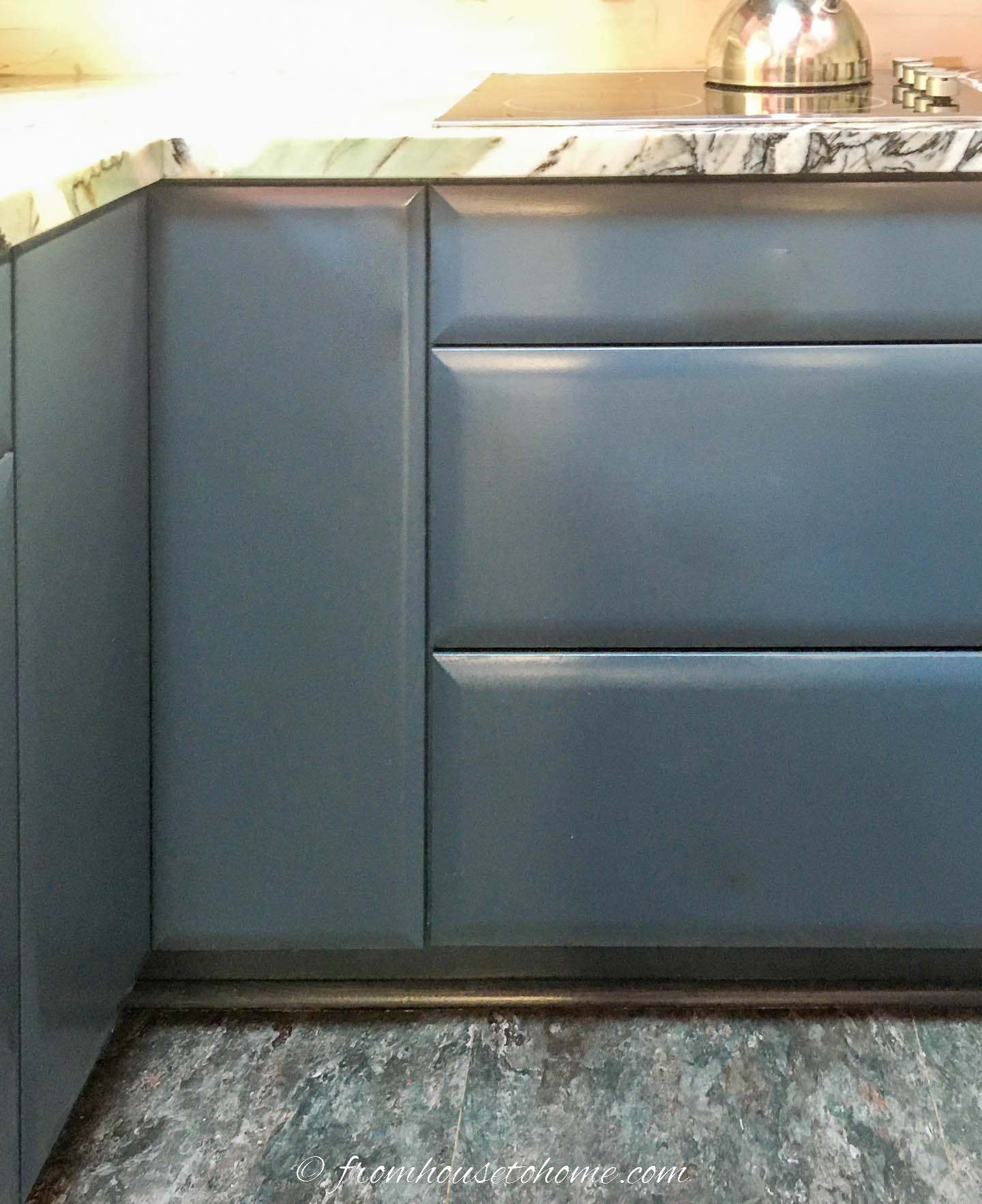 The bottom kitchen cabinets painted dark teal (Sherwin Williams 'Sea Serpent')