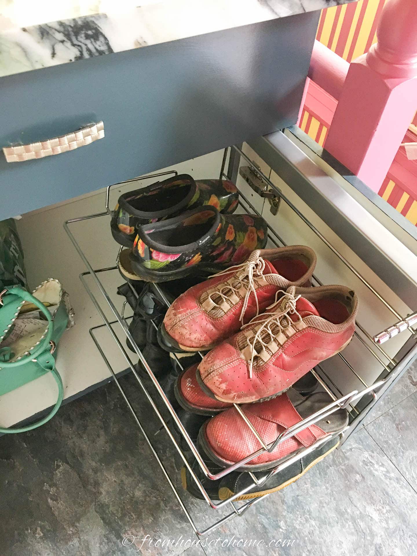 Pull-out shoe rack installed in a base cabinet
