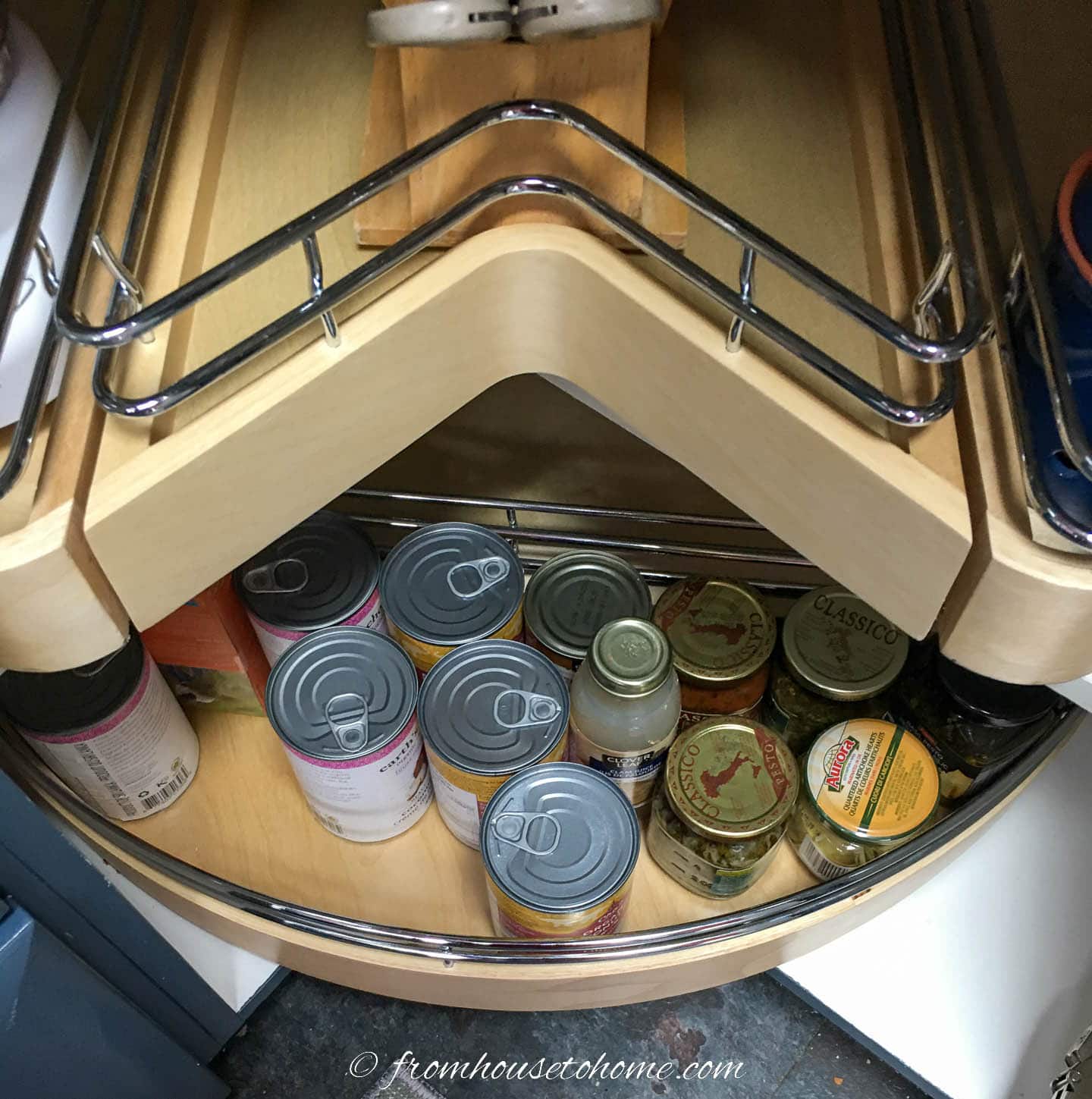 Corner cabinet lazy susan organizer with cans on it