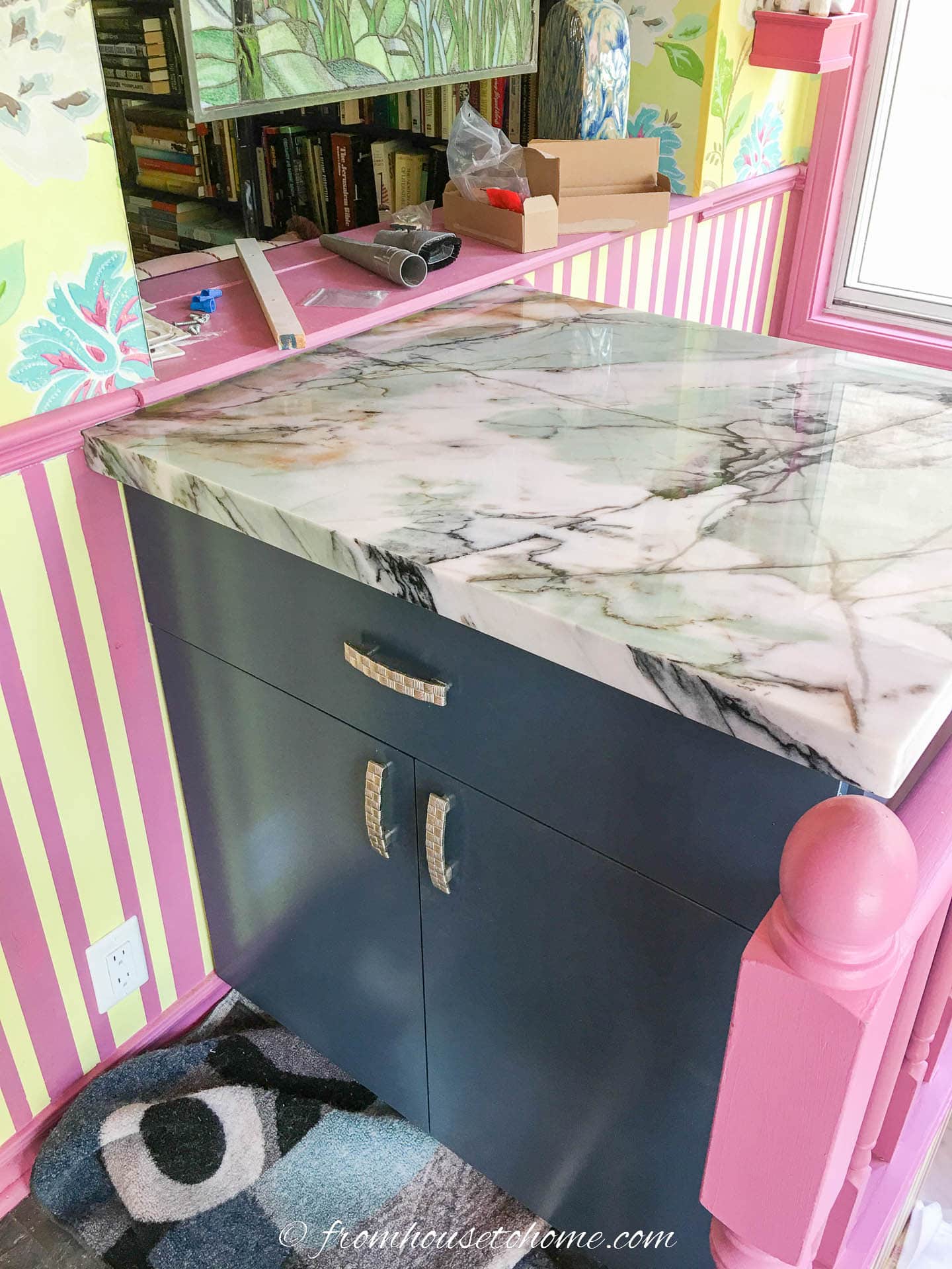Teal base cabinet with a teal, white and black quartzite countertop