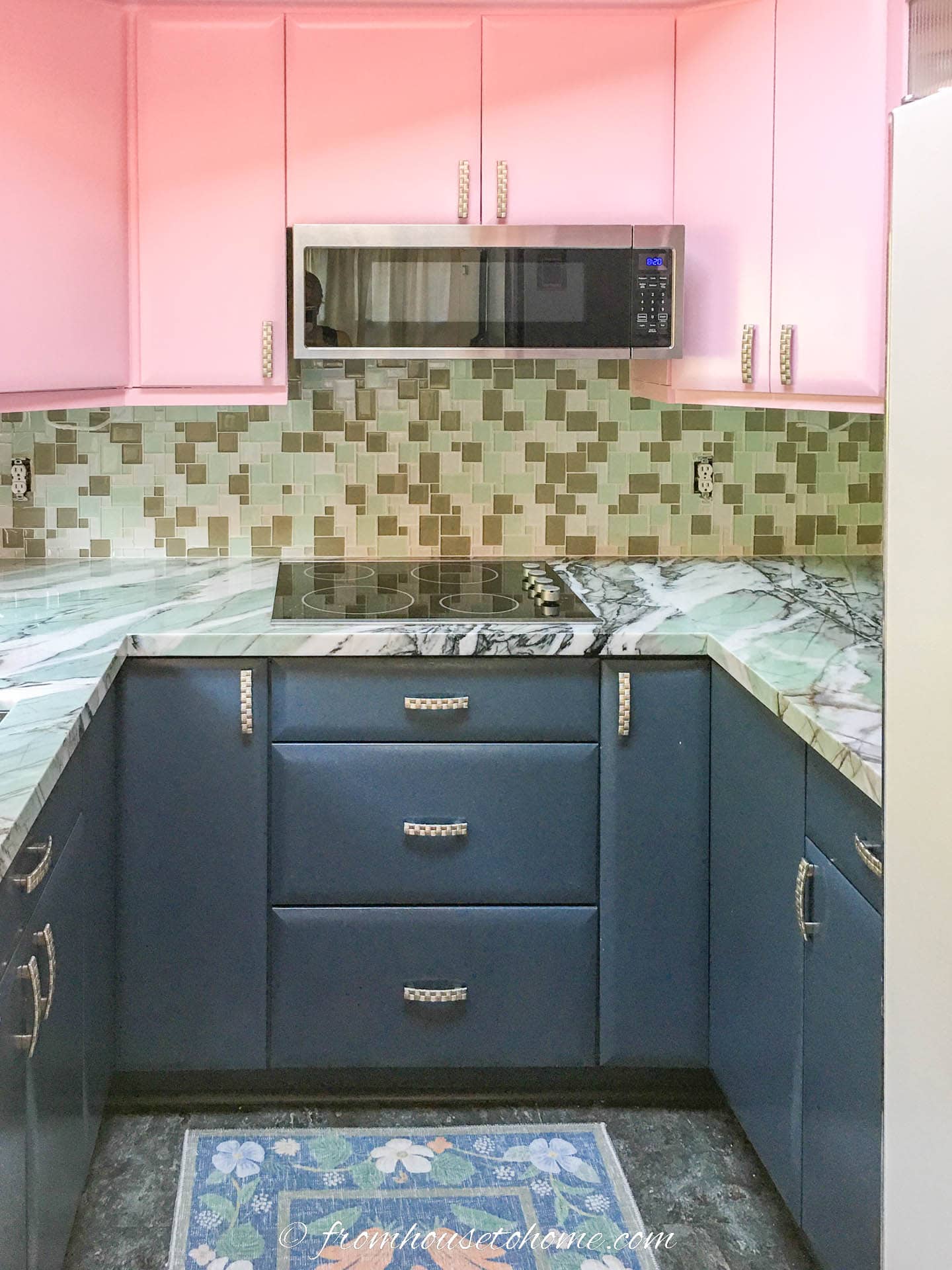 "After" picture of a pink and blue kitchen with quartzite countertop and glass mosaic backsplash