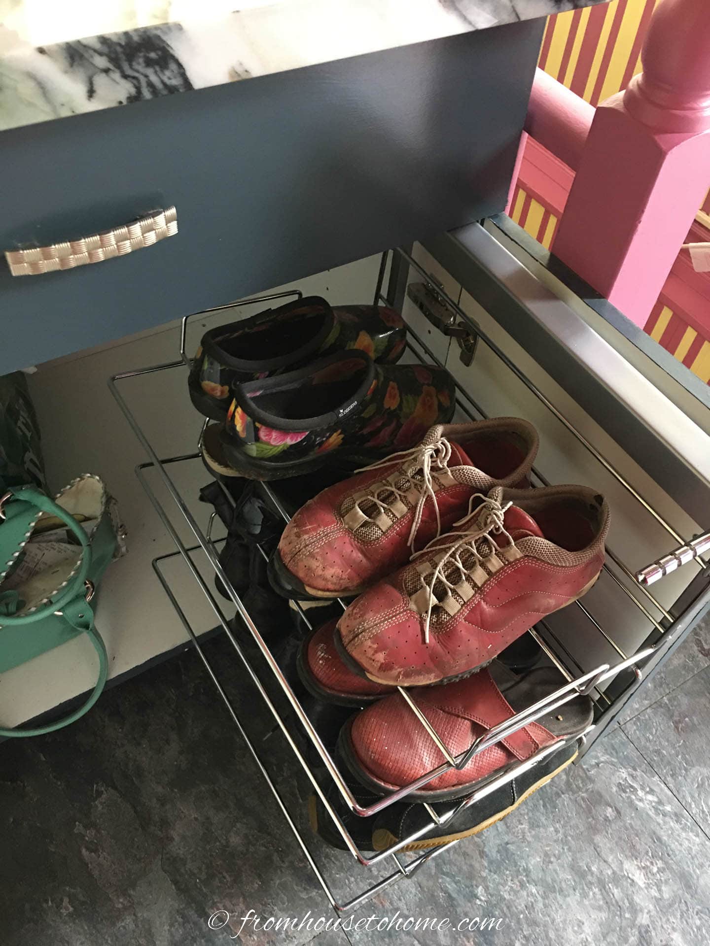 Shoes stored on a pull-out rack in a base cabinet
