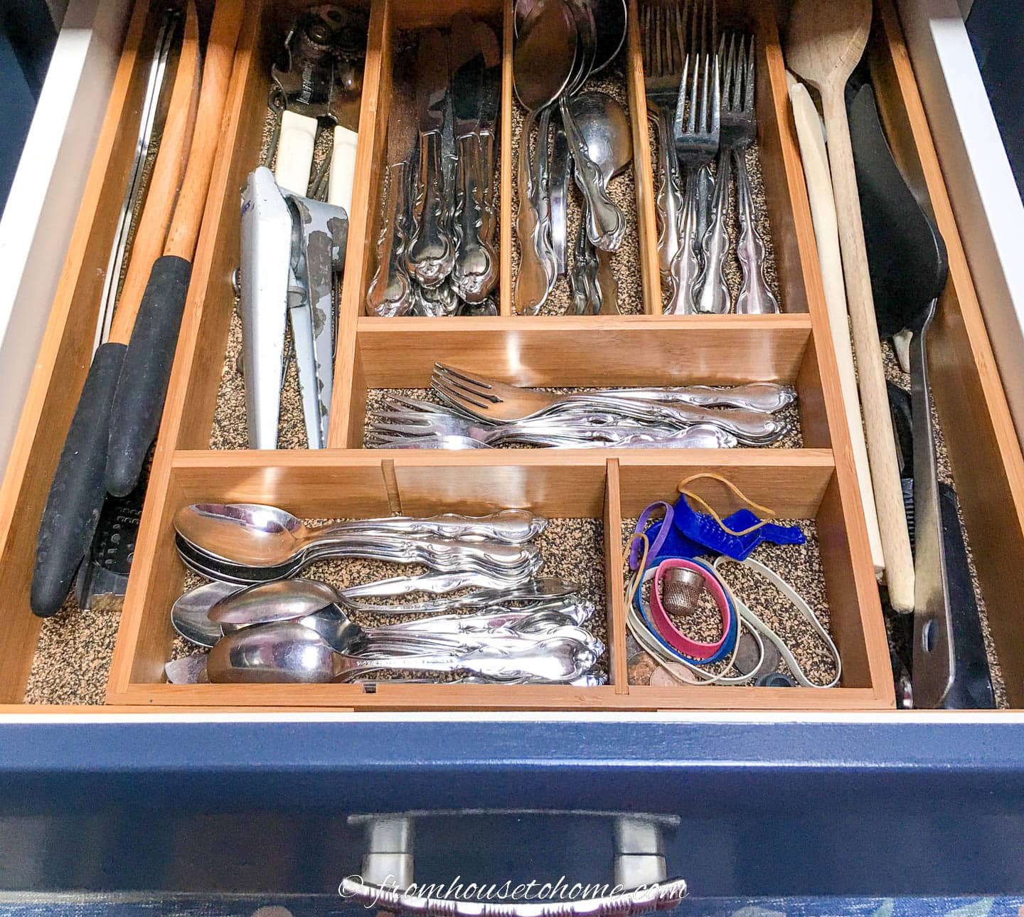 Kitchen drawer with bamboo dividers containing silverware