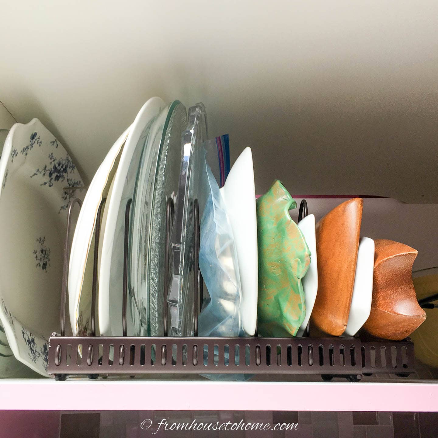 Pot rack used as large platter storage above the refrigerator