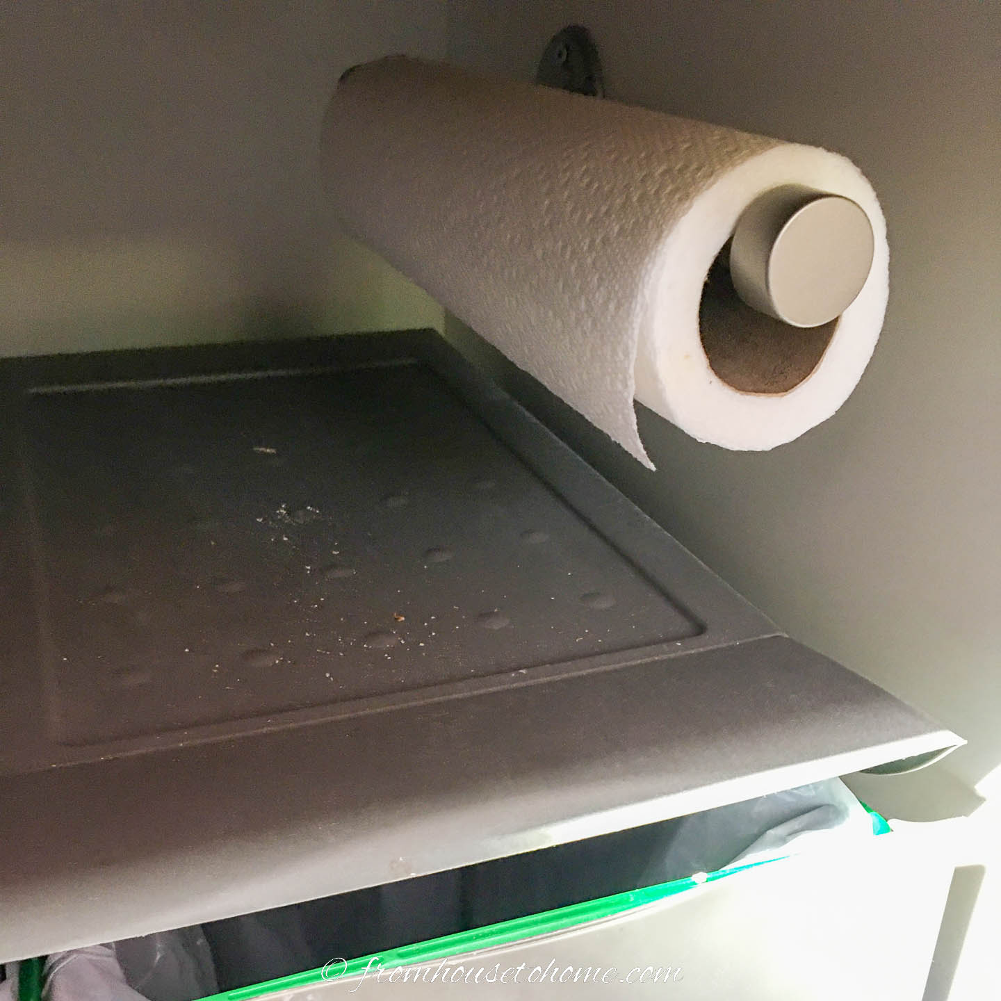 Side-mounted paper towel roll inside a kitchen cabinet
