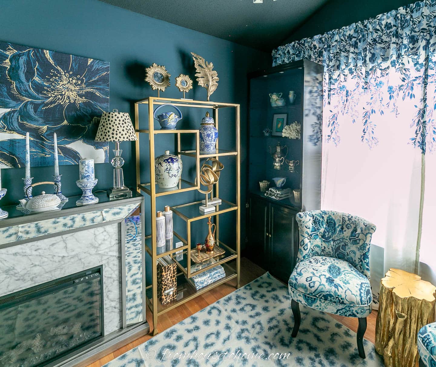 Fireplace and gold shelves in a dark blue and white home office