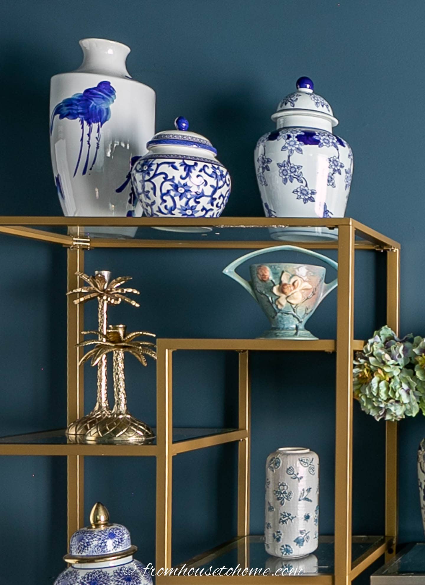 Blue and white Chinoiserie jars on a gold etagere shelf
