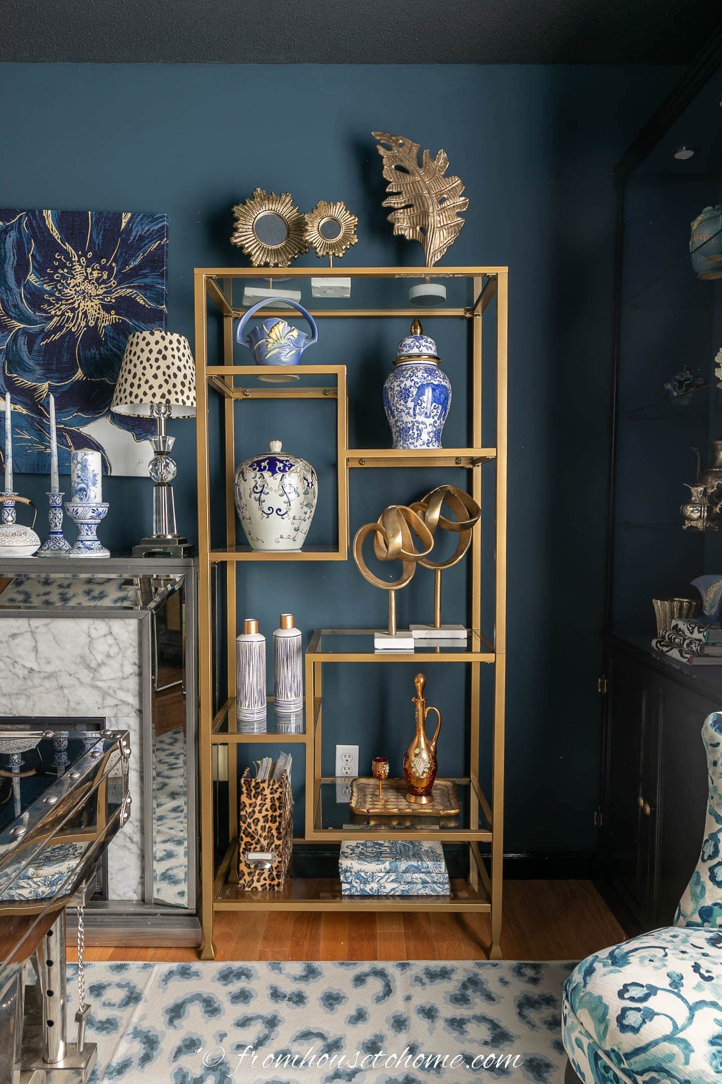 A decorated gold and glass etagere shelf