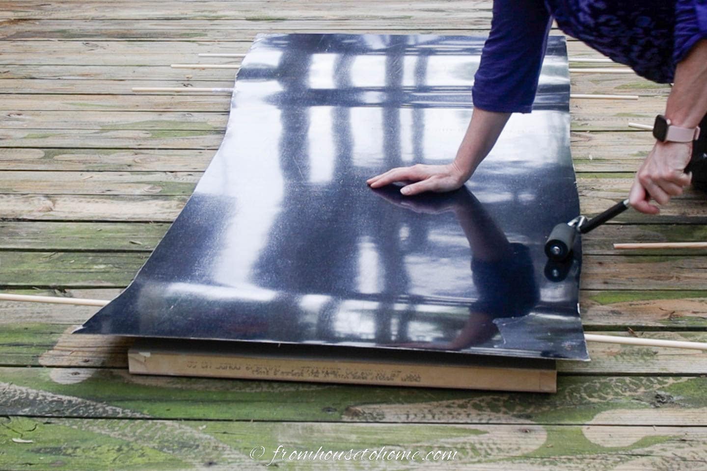 laminate being rolled onto a door