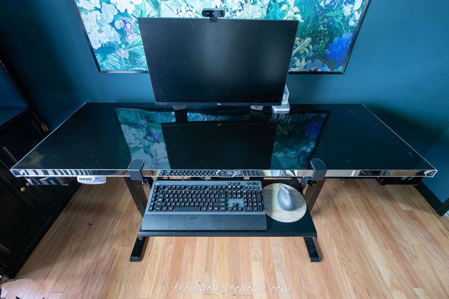 The finished DIY electric sit stand desk with a black and mirror desktop