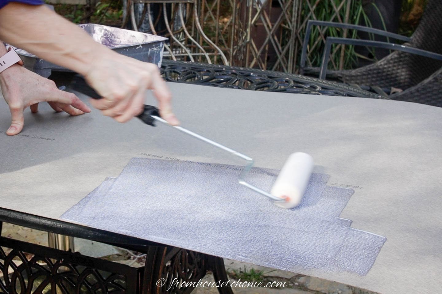 contact cement being rolled onto the back of a piece of laminate