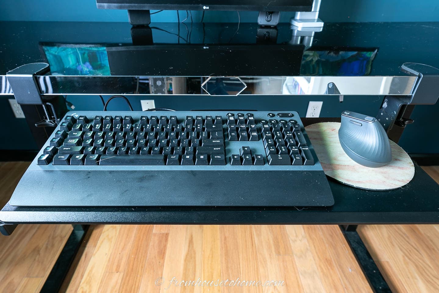 A wireless keyboard and mouse on a keyboard tray