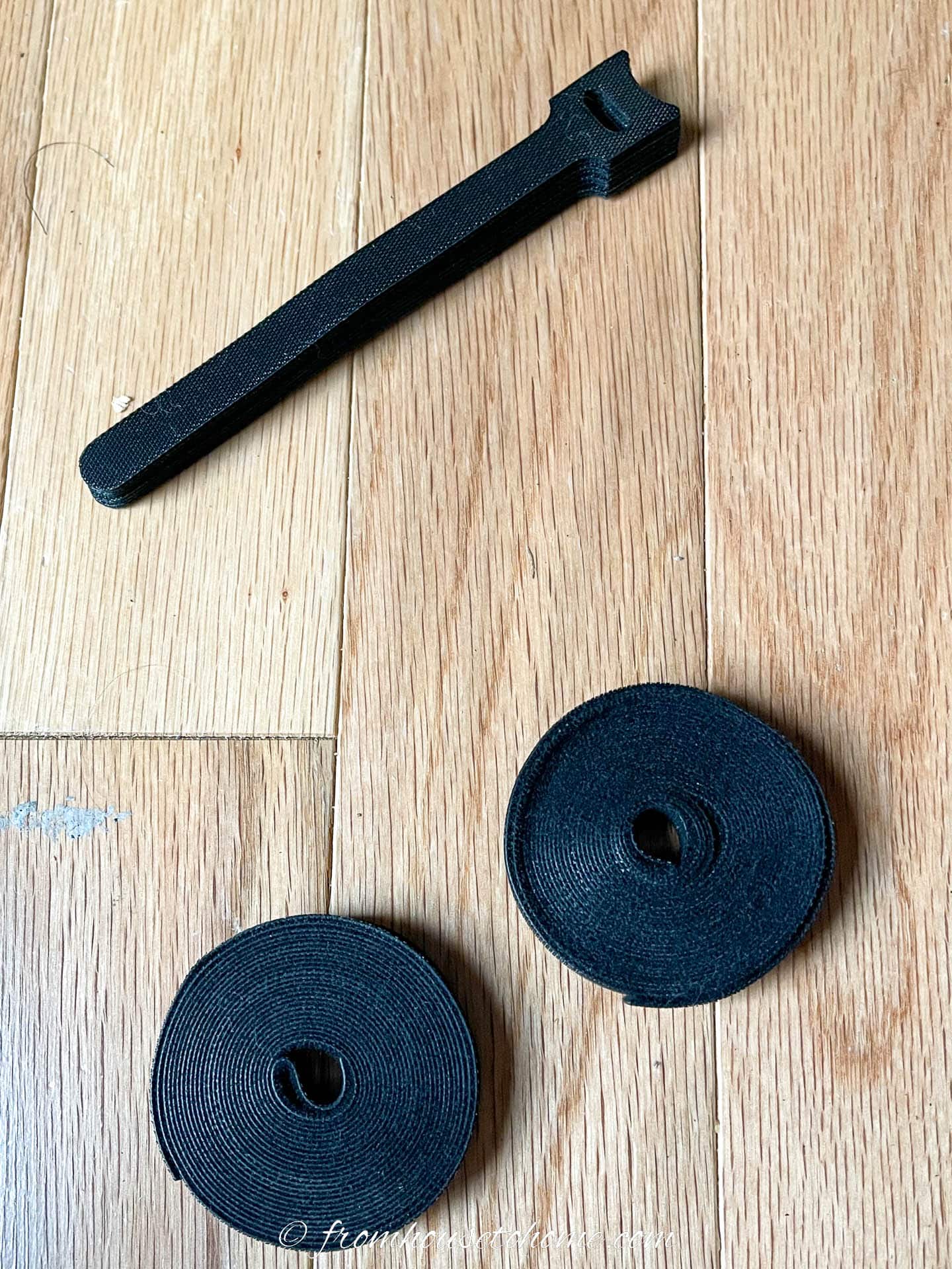 Two types of velcro ties on a wood background