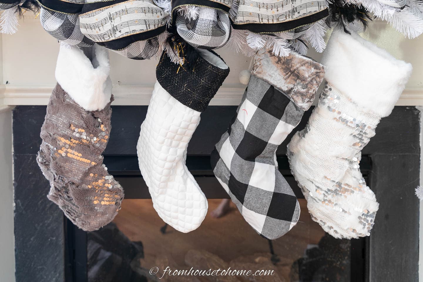 Black and white stockings hung on a fireplace