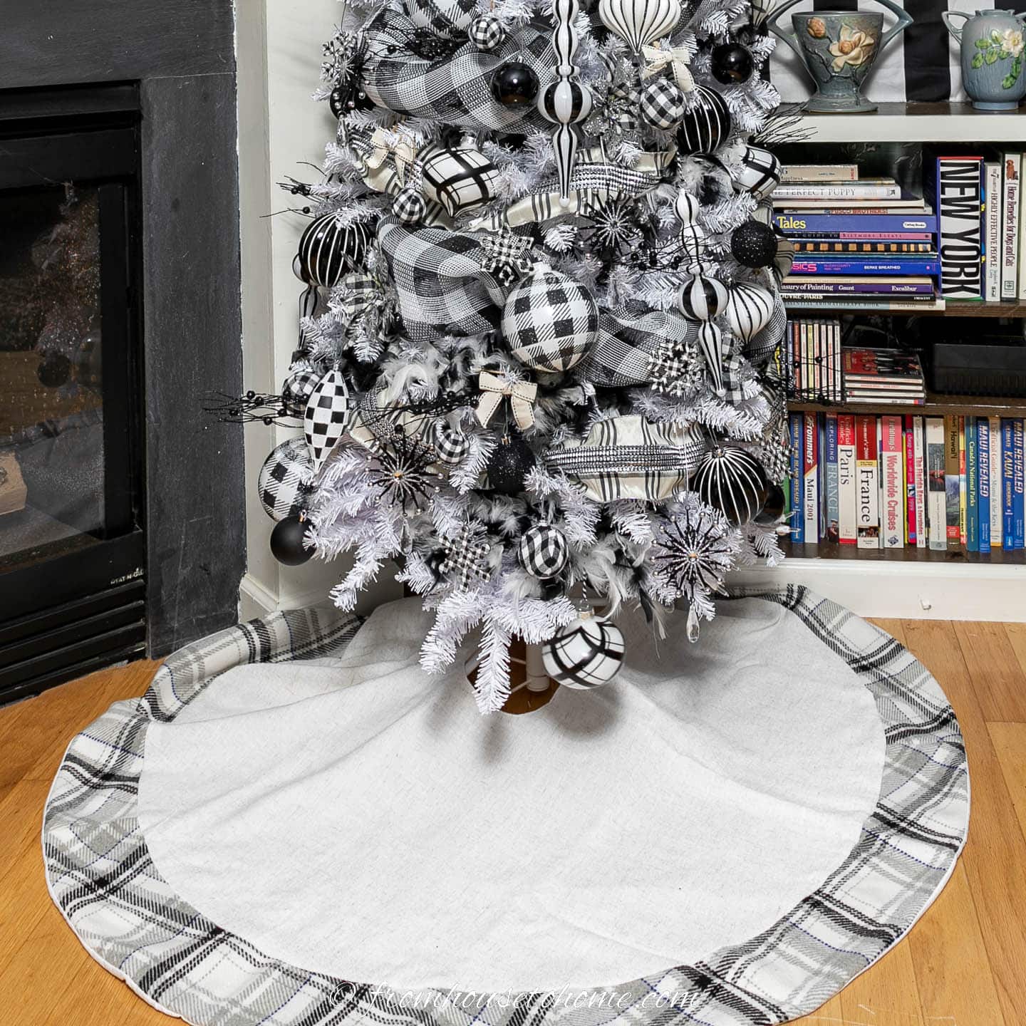 Black and white plaid tree skirt under a Christmas tree