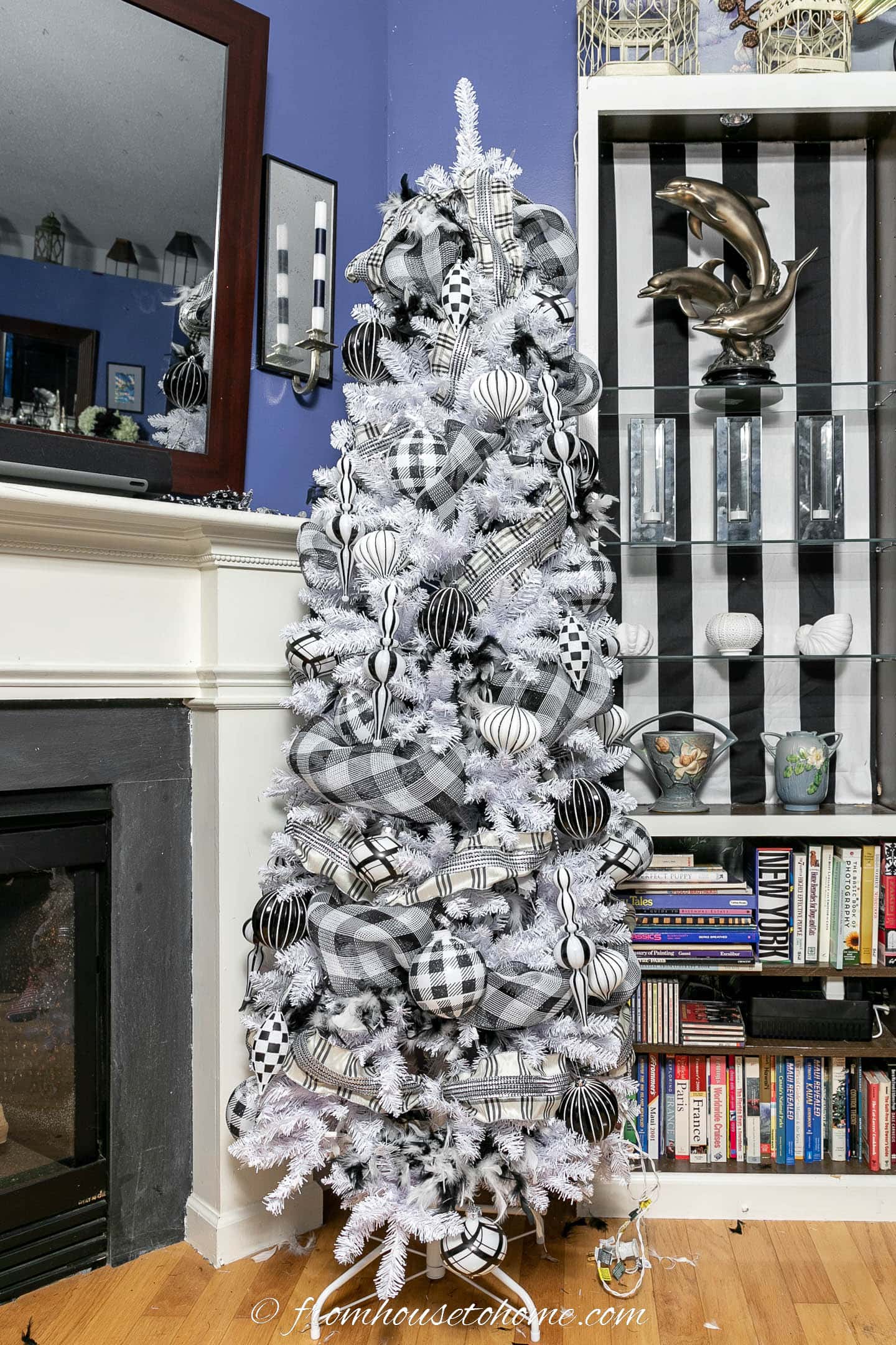 White Christmas tree with black and white feather boas, buffalo check deco mesh, plaid ribbon and large and long black and white ornaments