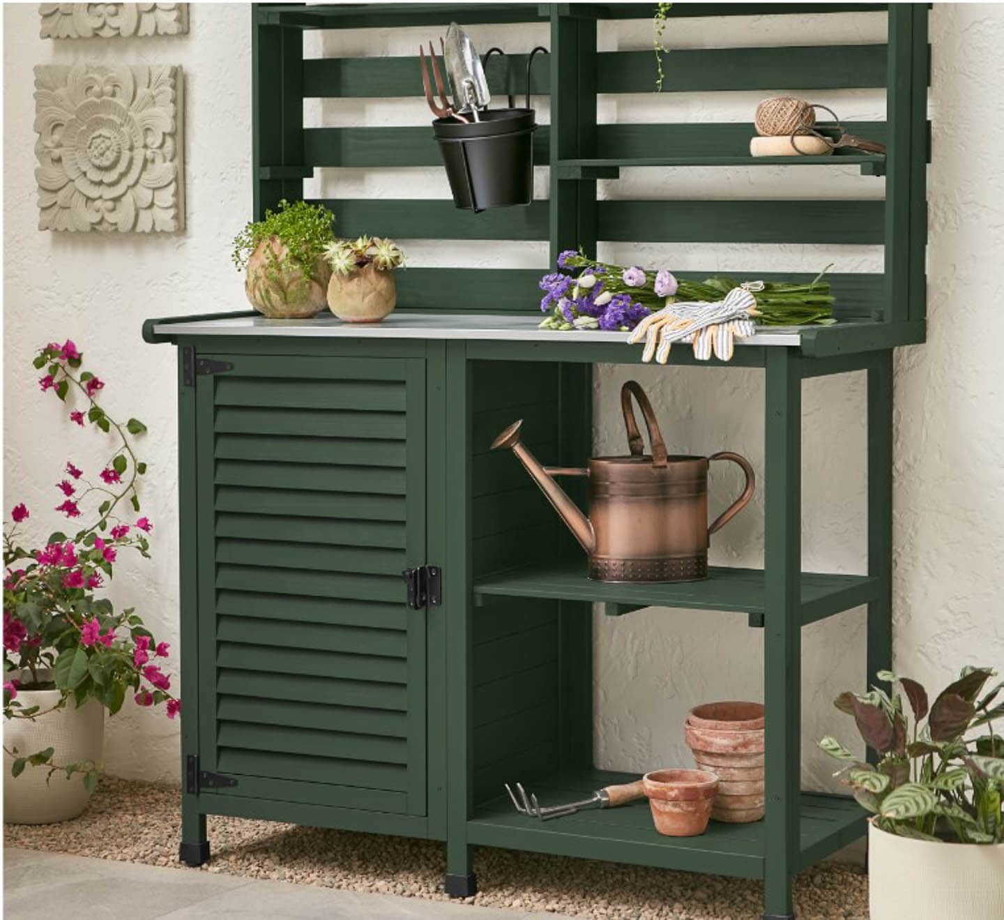 A garden bench painted in Krylon's 2023 color of the year - Spanish Moss