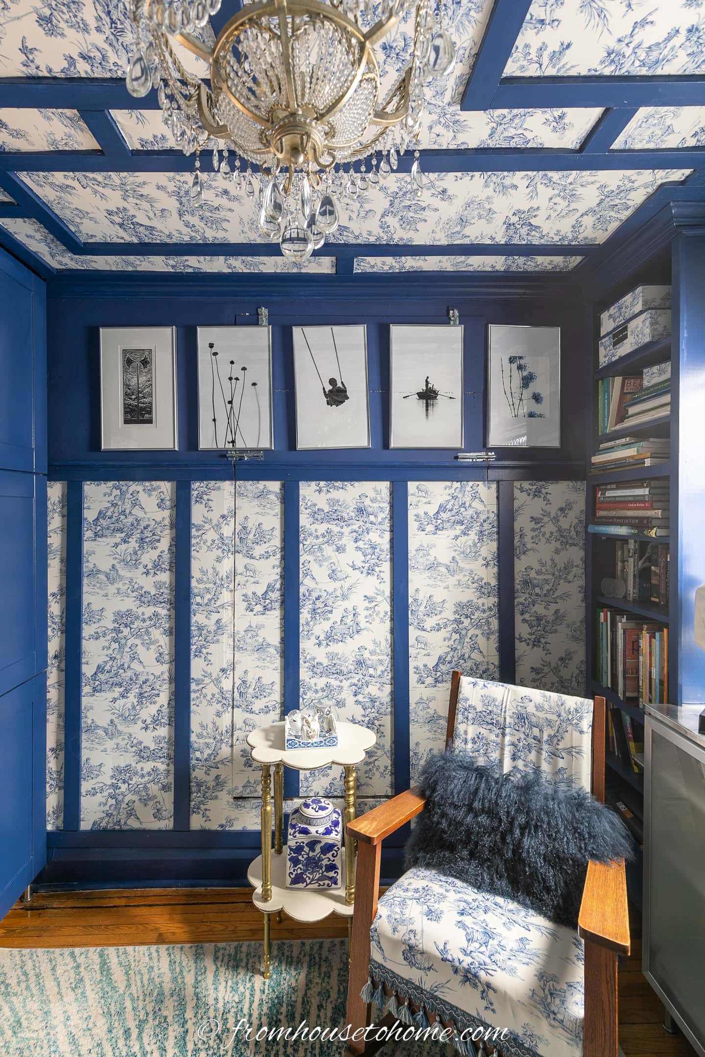 A sitting area in a small home office decorated with blue and white toile