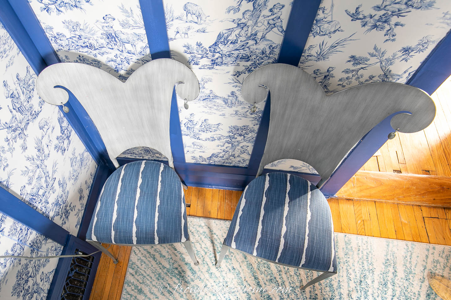 Two silver chairs with seat covers in blue and white striped fabric