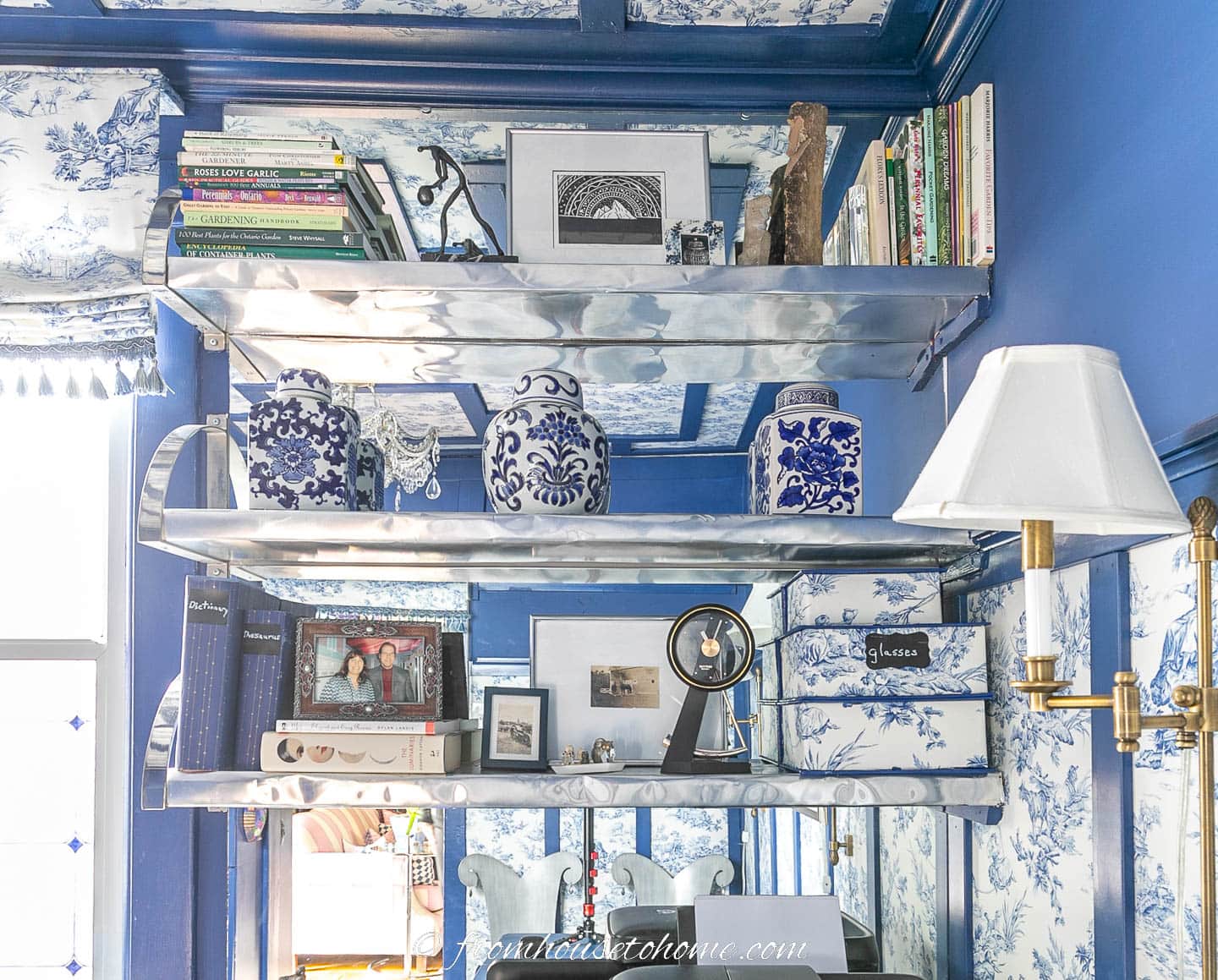 Silver and mirror shelves styled with accessories in a blue and white room