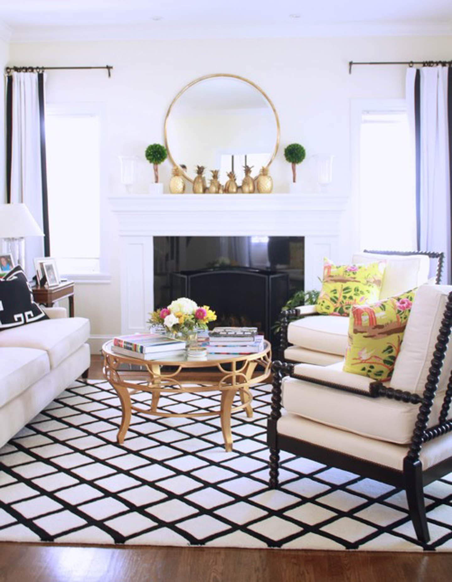 White living room with black and white furniture and area rug and a round gold table