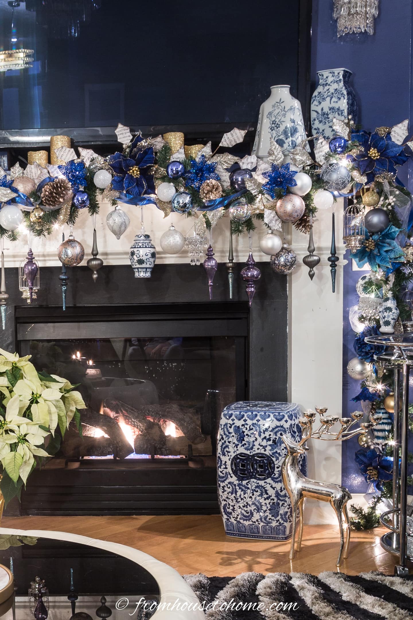 A living room with a fireplace decorated with blue and white ornaments.