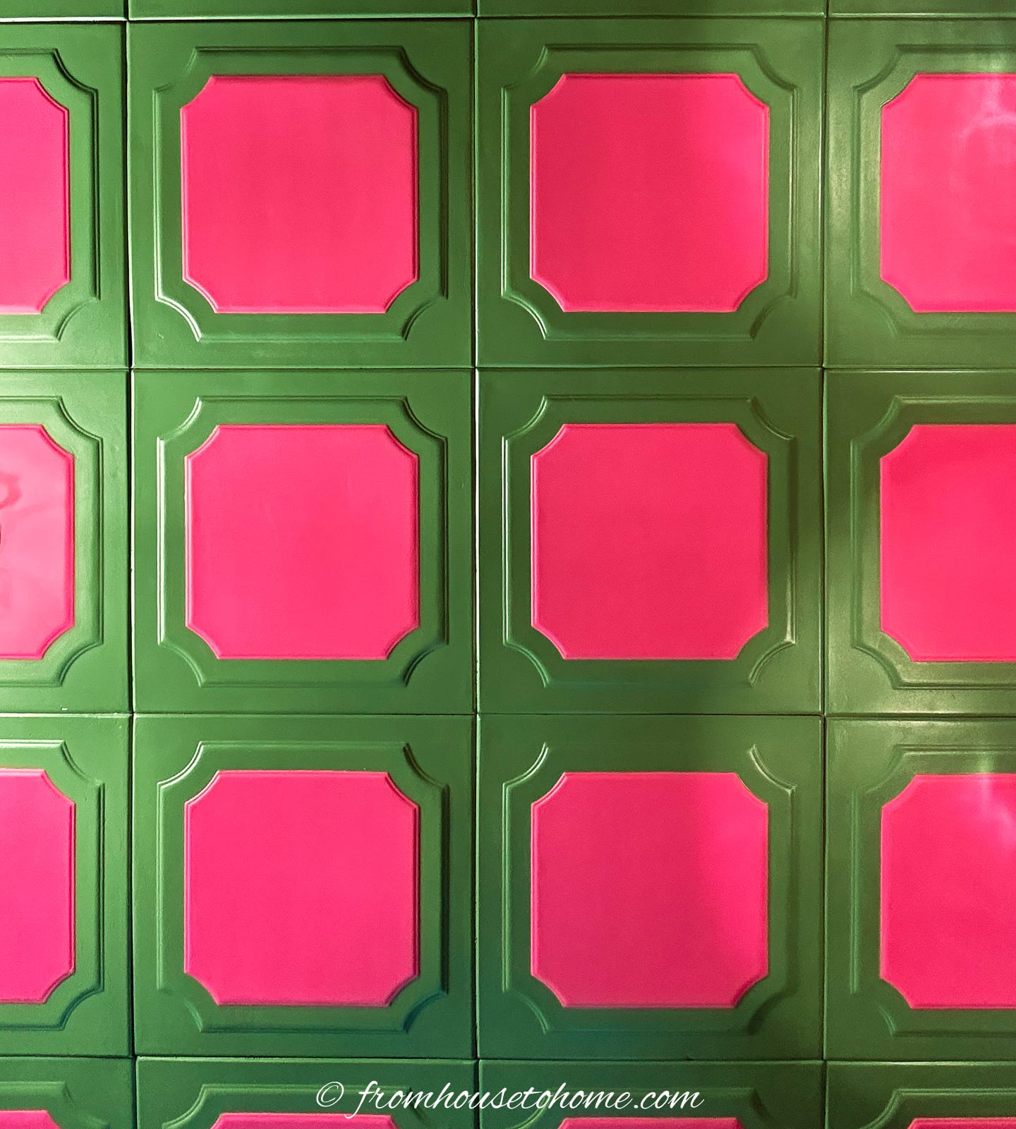 A green and pink tiled ceiling with squares.