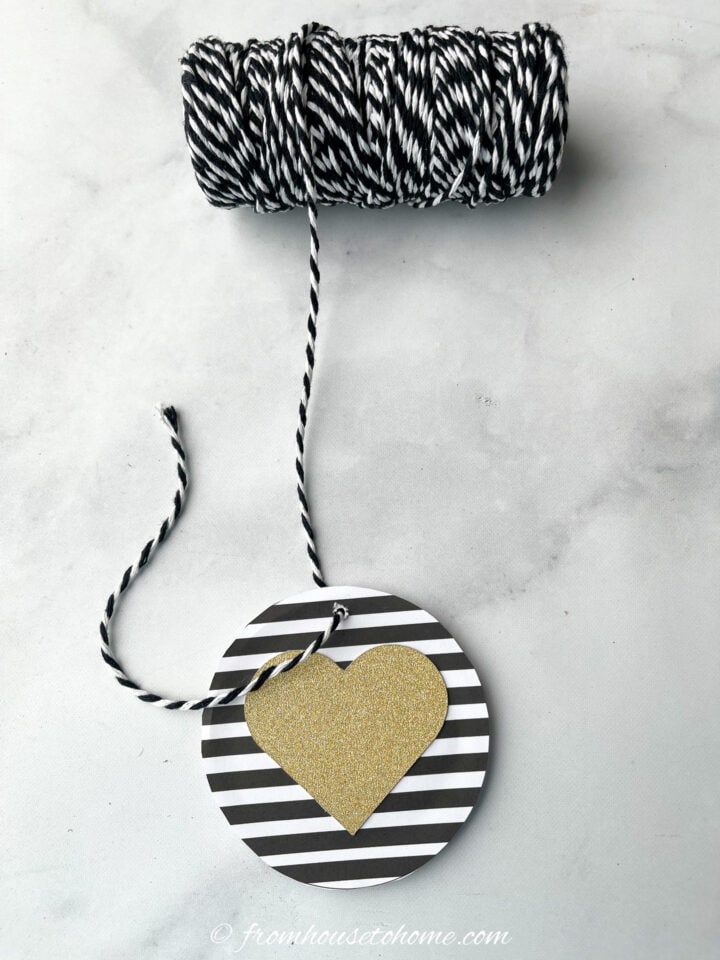 A DIY heart Christmas ornament with black and white string