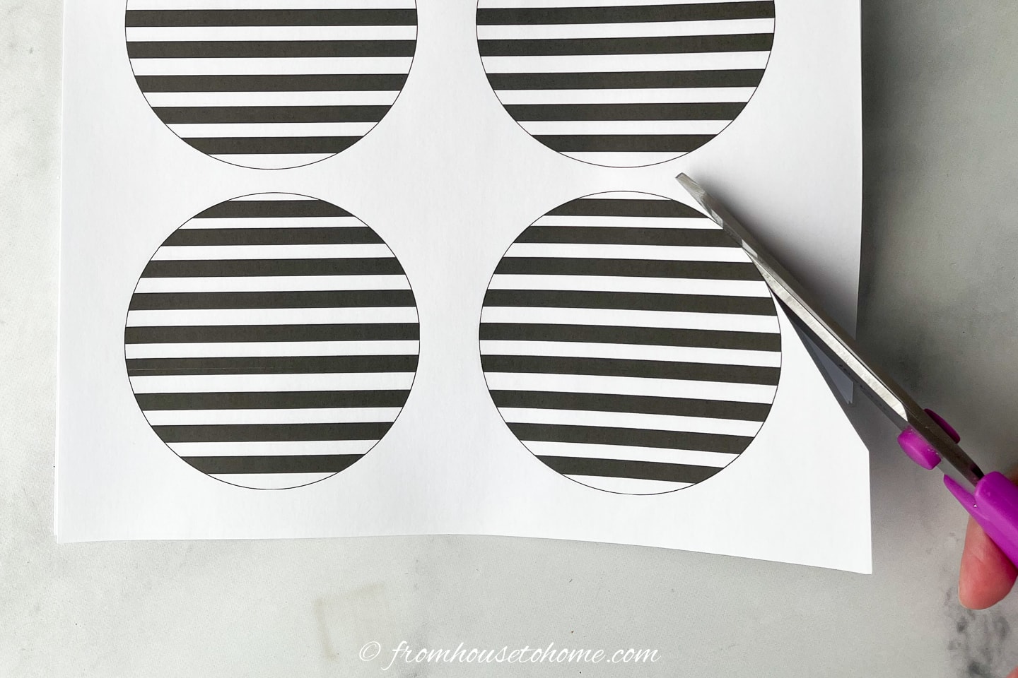 Black and white striped circle being cut with scissors