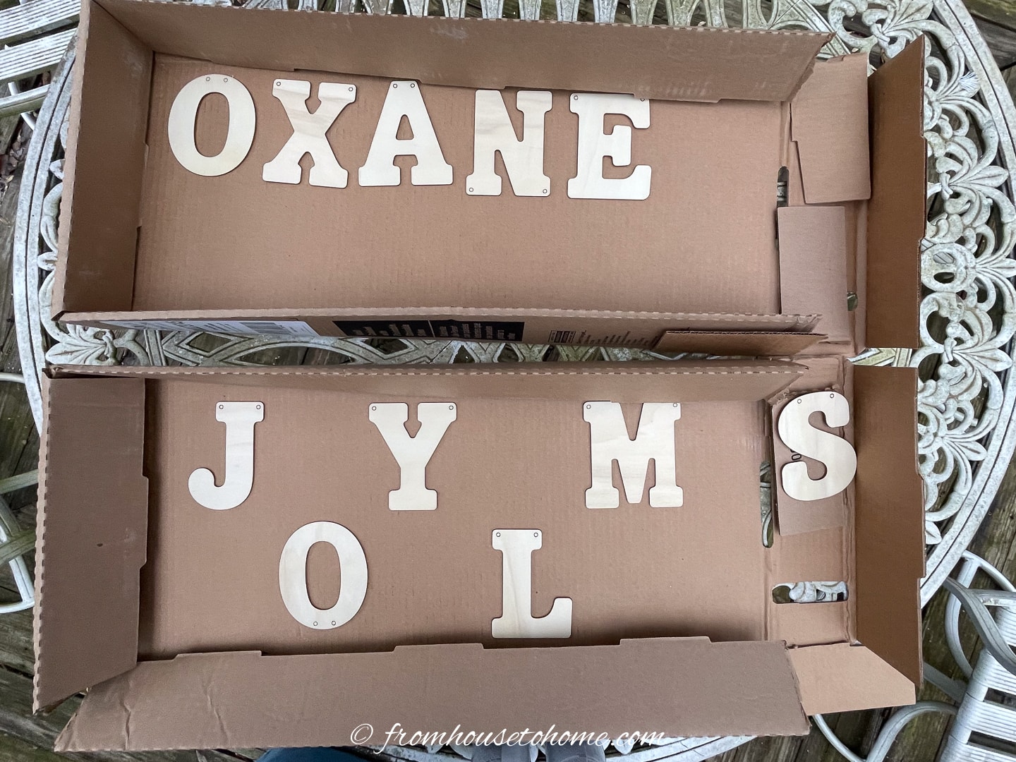 Wood letters spread out in two cardboard boxes