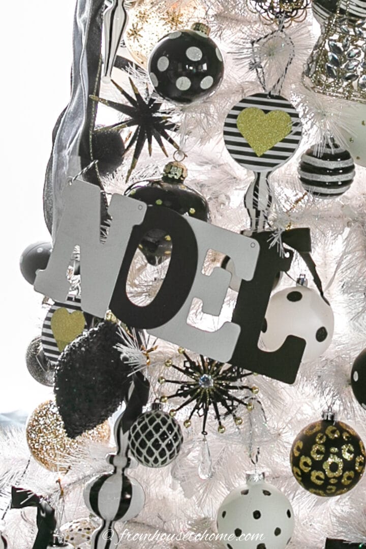 Black and white letter ornament on a white Christmas tree