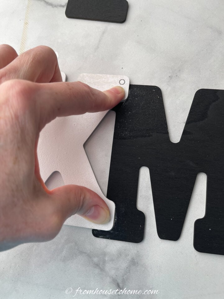 Letters being glued together