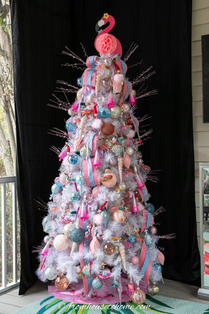 A festive flamingo Christmas tree adorned with pink and blue ornaments.