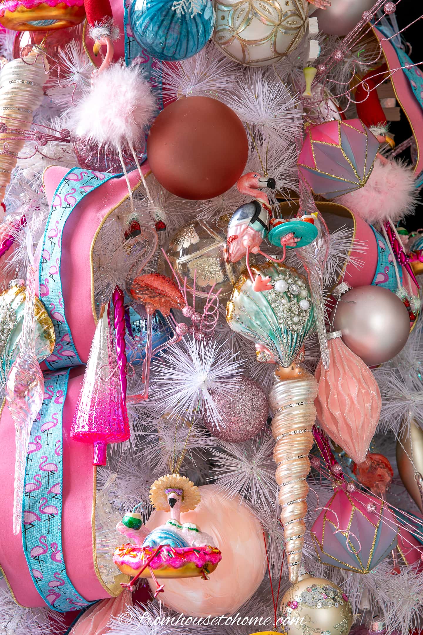 A flamingo-themed Christmas tree decorated with pink and teal ornaments.