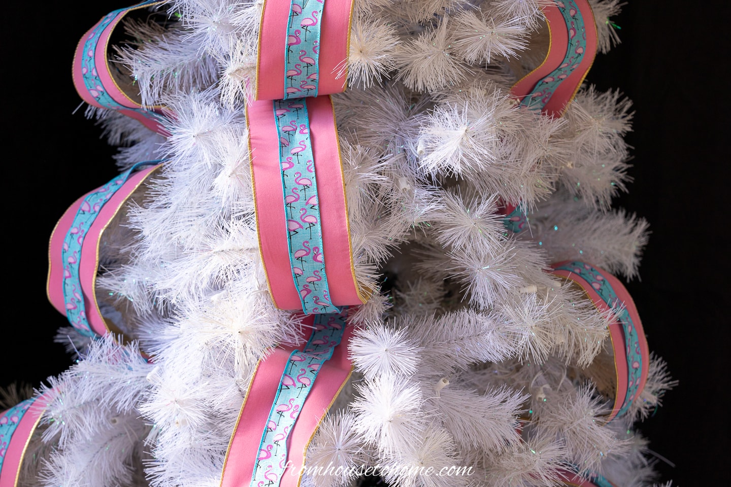 Pink and blue layered ribbon on a white Christmas tree