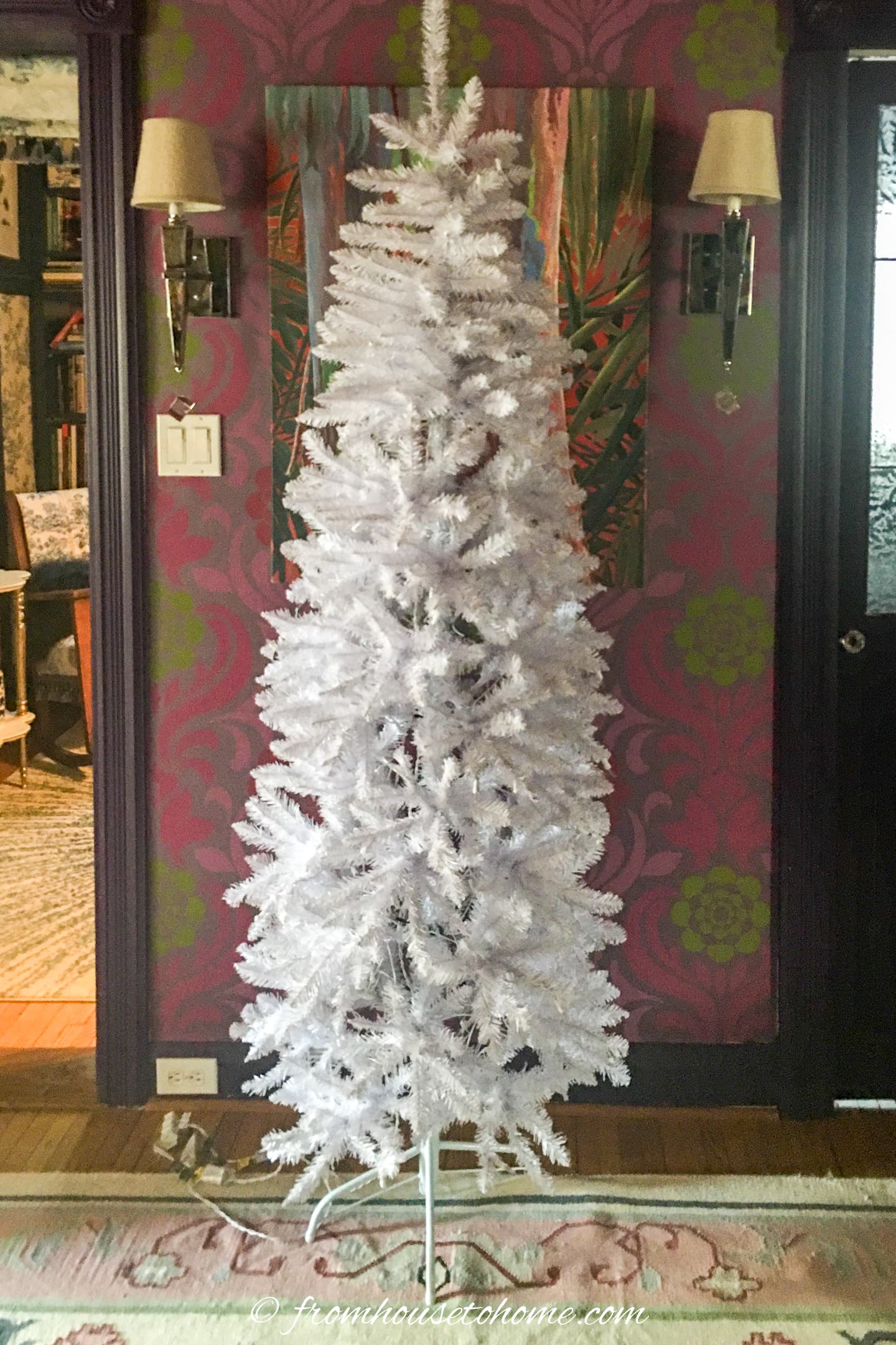A white Christmas tree in a living room.