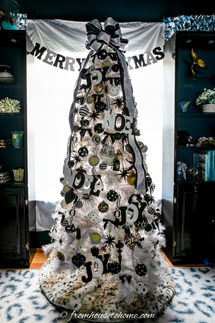 A white Christmas tree decorated with black decorations.