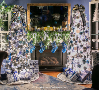 Simple garland with blue and white ribbons between two blue and white Chinoiserie Christmas trees with white lights