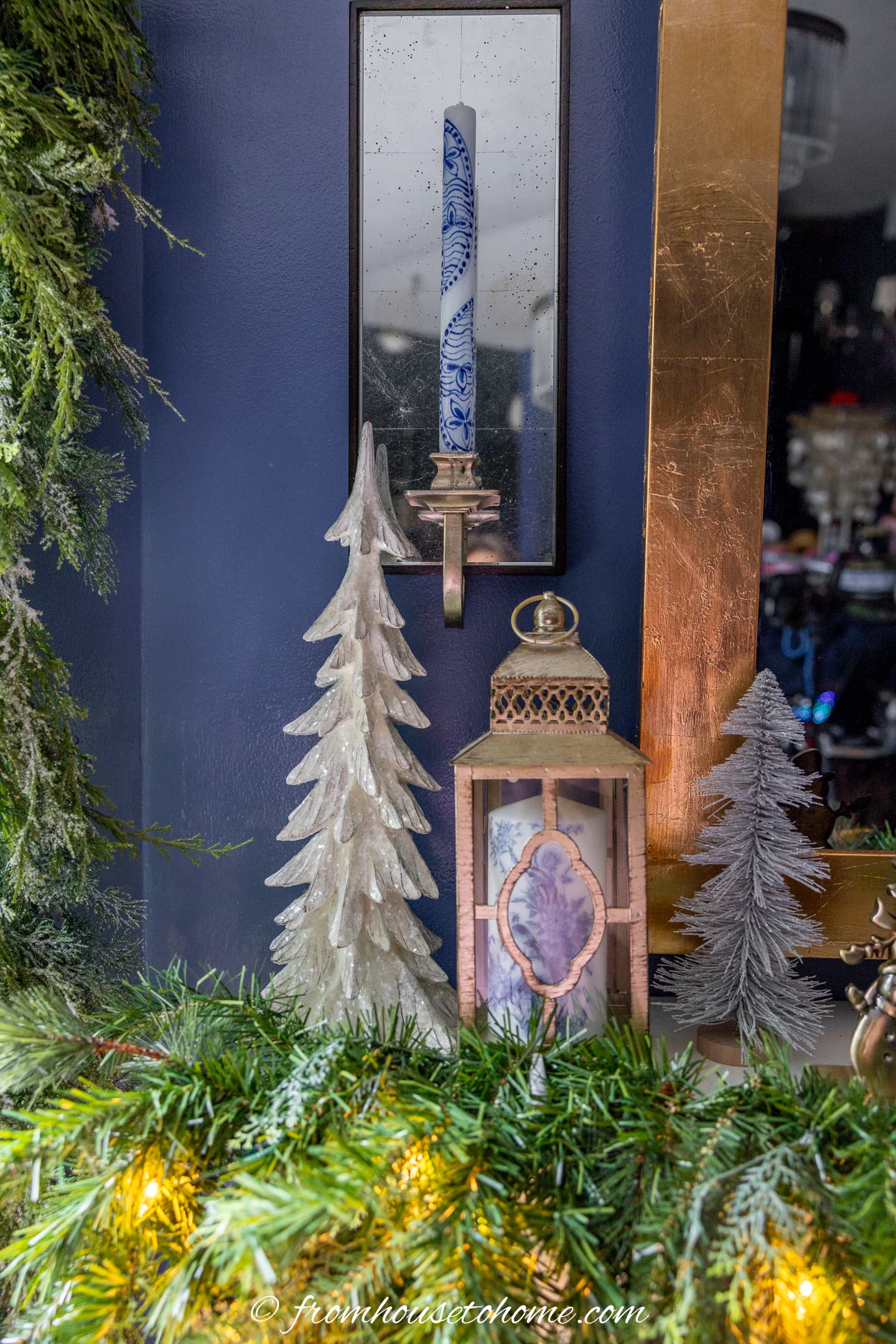 Blue and white candles on a fireplace mantel