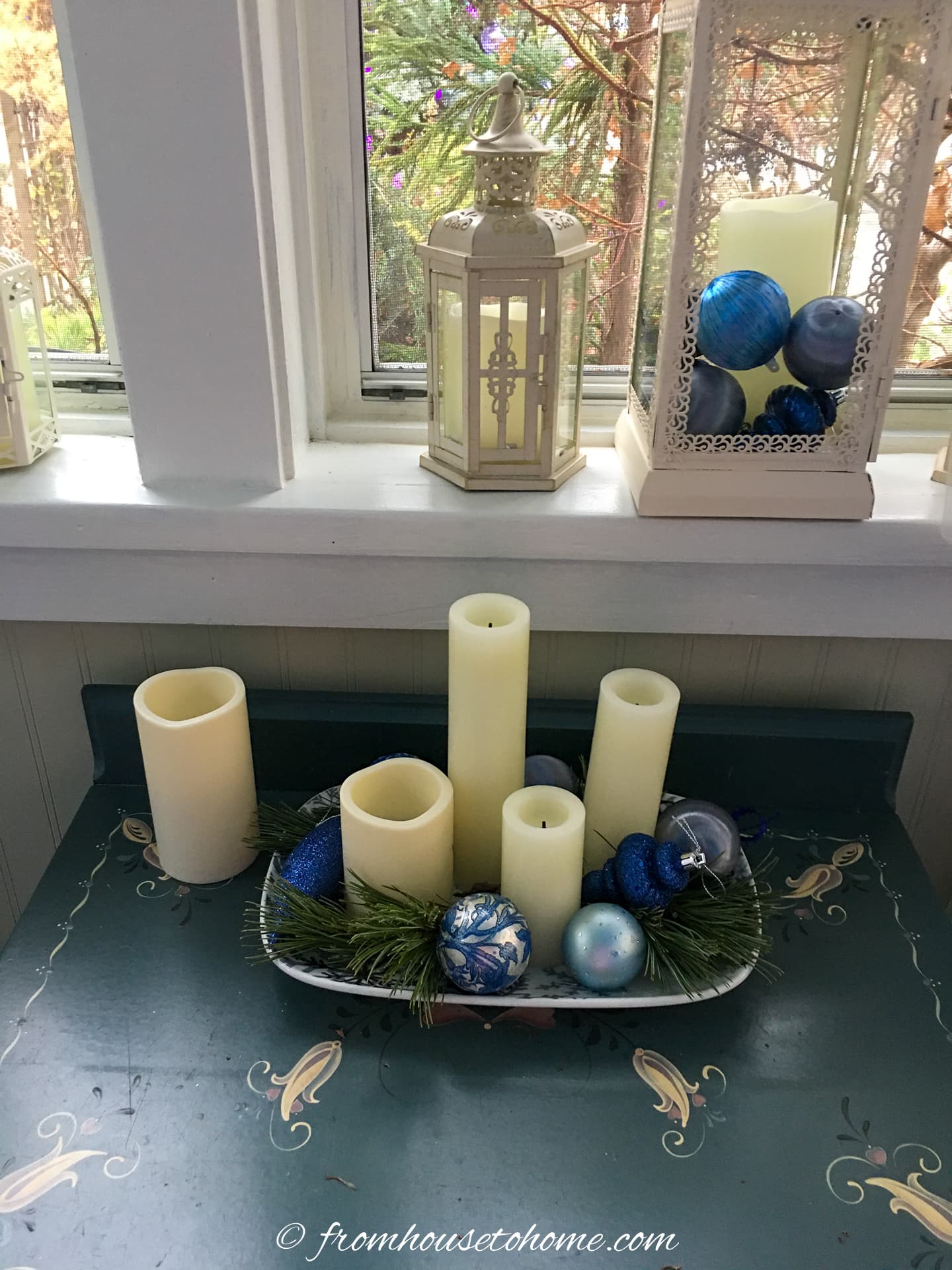 Candles on a tray with Christmas ornaments