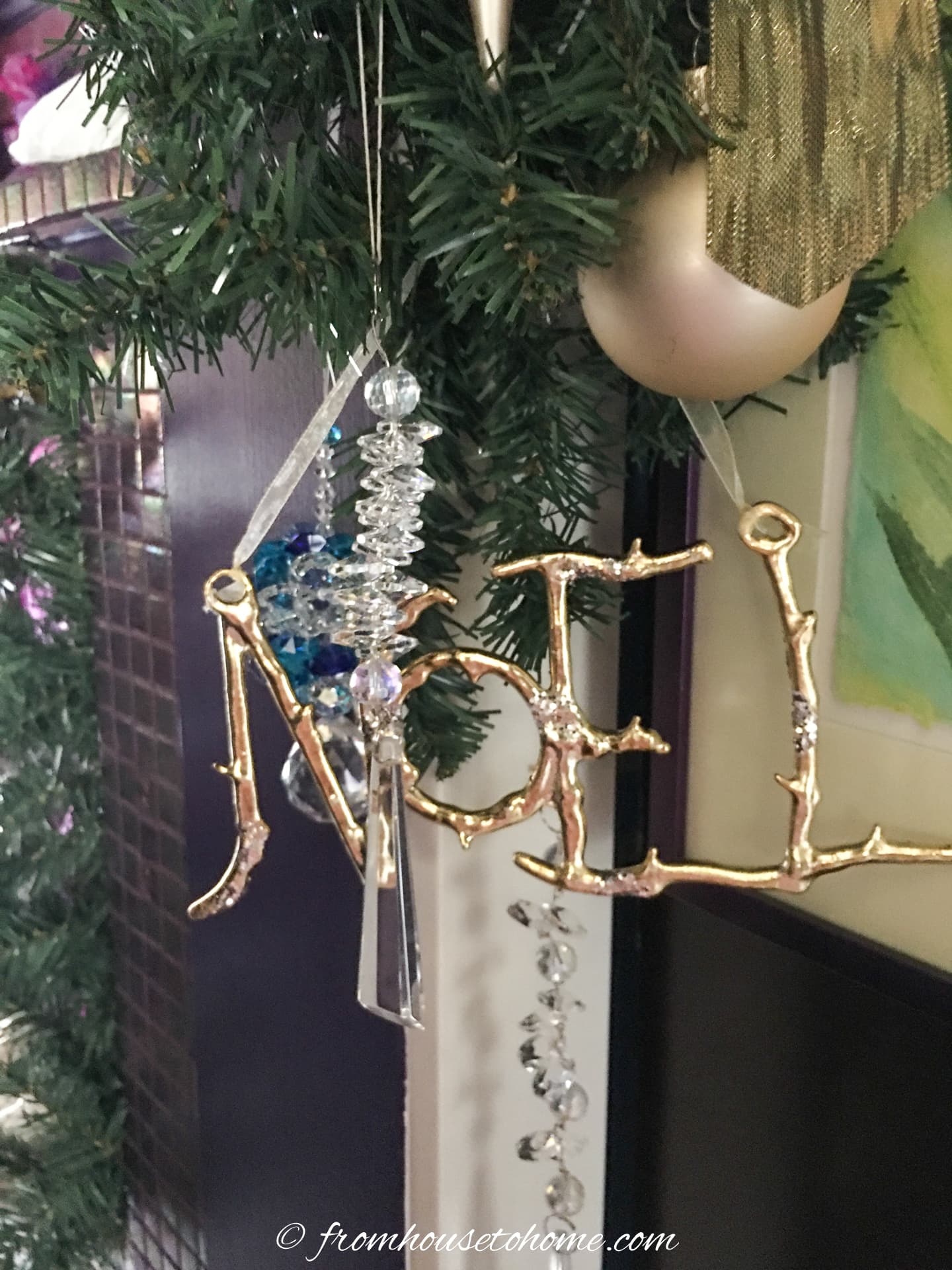 Gold and crystal ornaments hung from a green garland