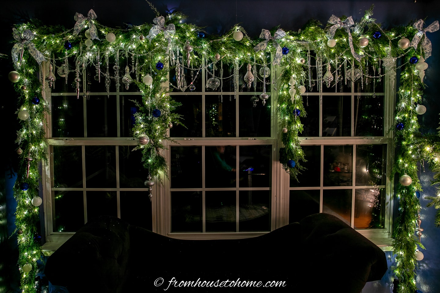 Lighted garland hung over a living room window