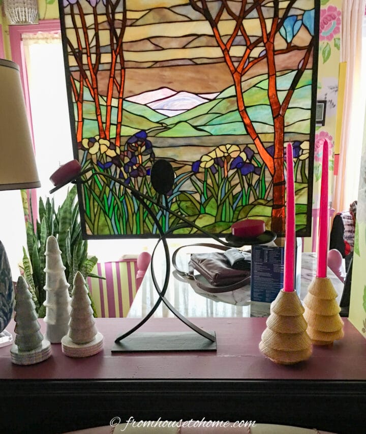 Candles and mini Christmas trees on a window ledge