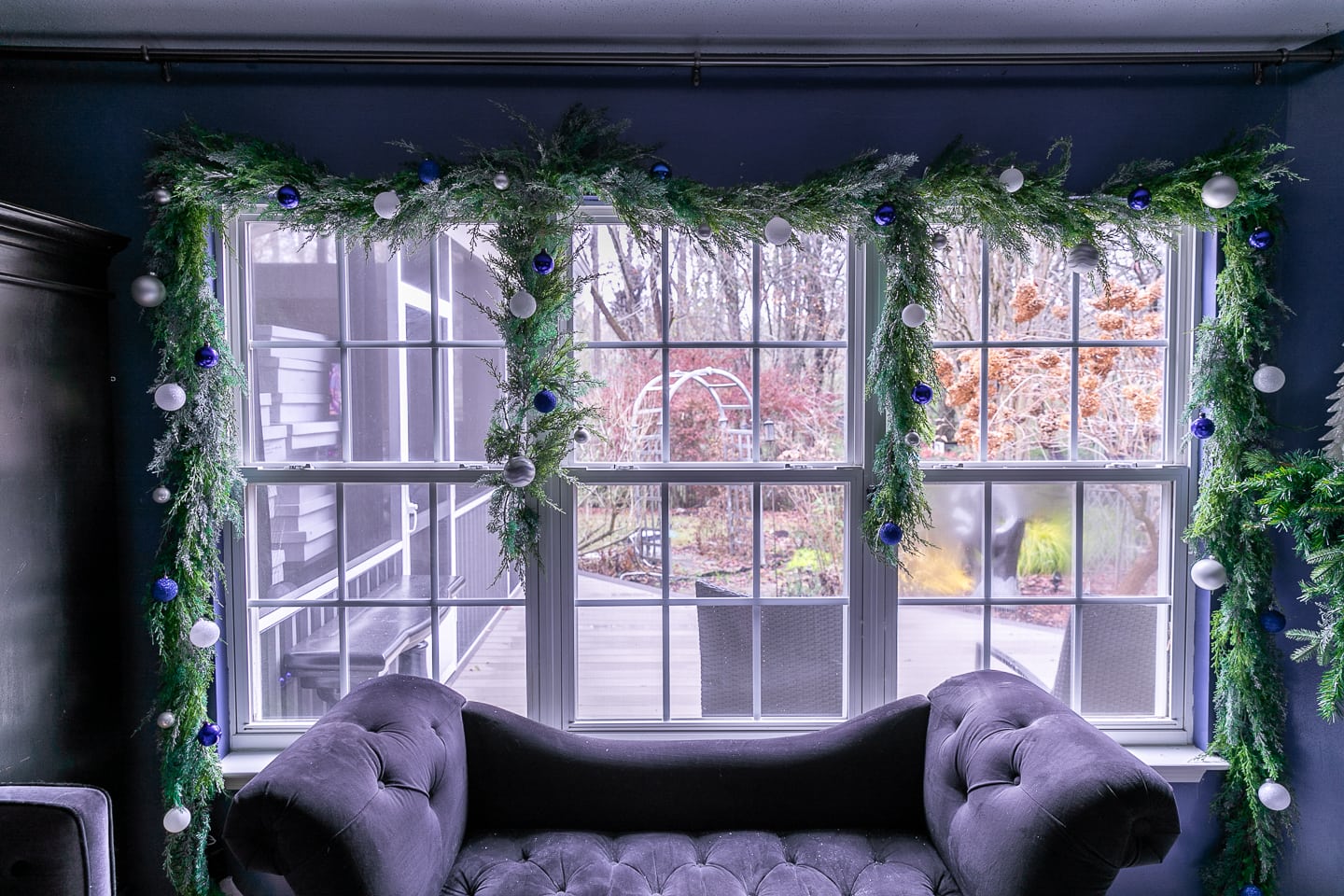 Christmas window garland decorated with blue and white ball ornaments