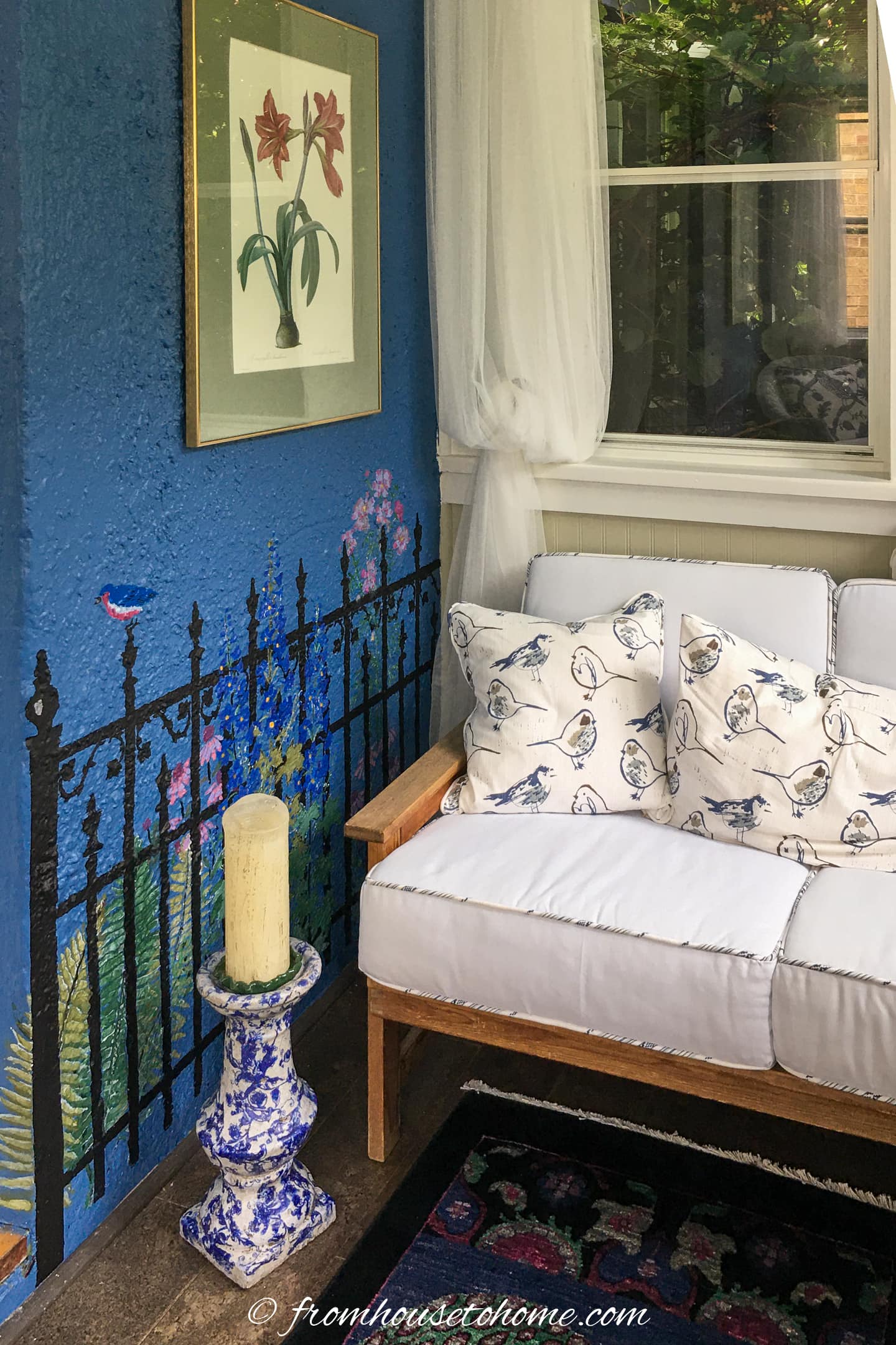 white outdoor sofa and blue and white candleholder in a front porch